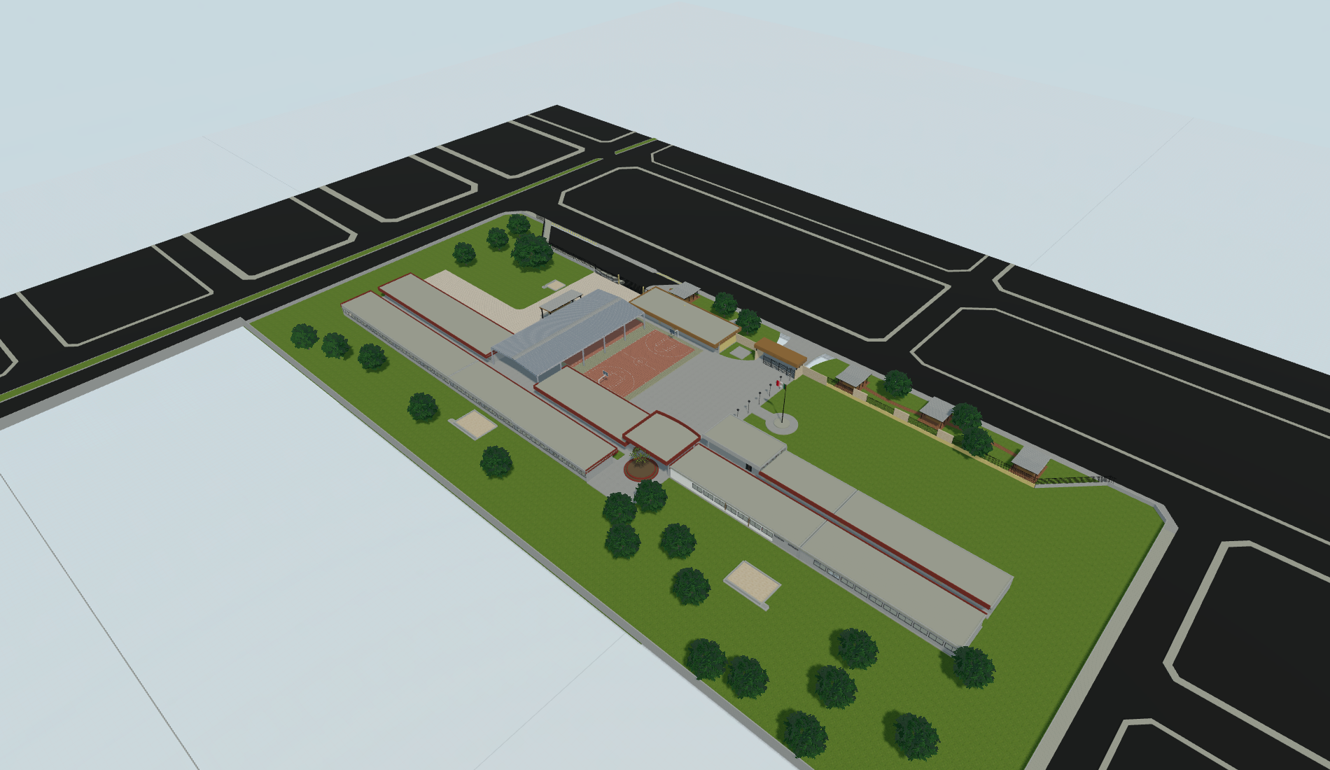 Escuela Raúl: vista de conjunto del modelo con edificios, cancha y áreas verdes